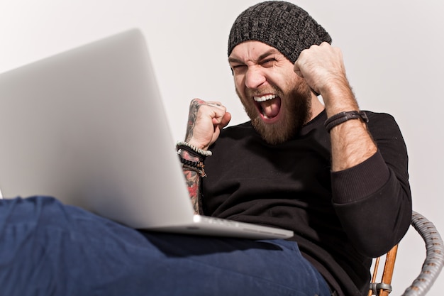 Young guy with a beard with a laptop