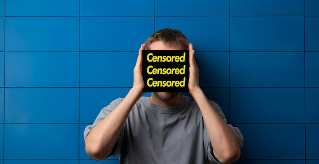 A young guy with a black tab covering hiding the face censored concept