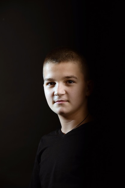 Young guy with a short haircut on a black clipping background