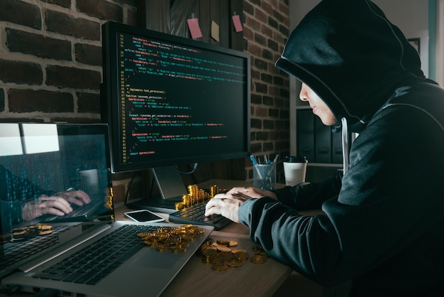 young hacker having many bitcoin through using data virus steal business information.