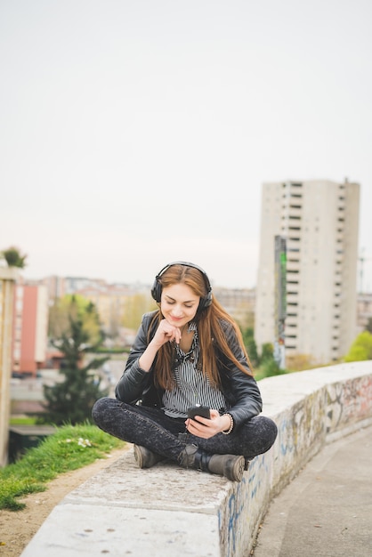 Young handosme brunette girl listening music