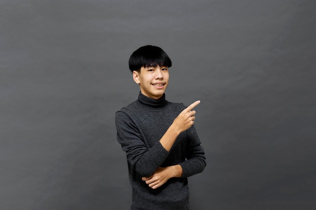 Young handsome Asian man posing at studio