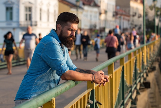 Young handsome bearded hipster man in the city