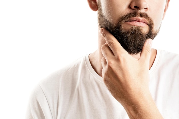 Young and handsome bearded man on white background