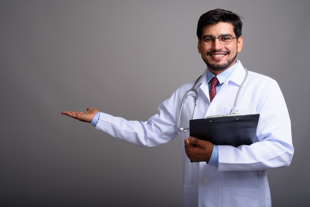 young handsome bearded Persian man doctor wearing eyeglasses 