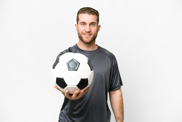 Young handsome blonde man over isolated white background with soccer ball