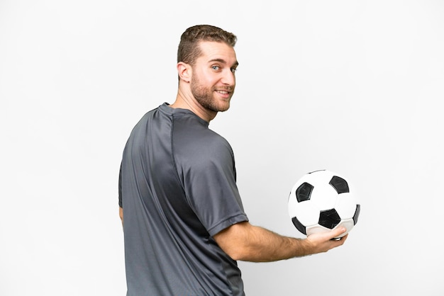 Young handsome blonde man over isolated white background with soccer ball