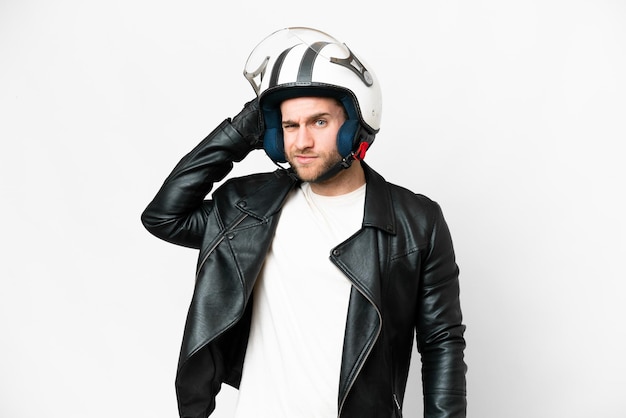 Young handsome blonde man with a motorcycle helmet over isolated white background having doubts