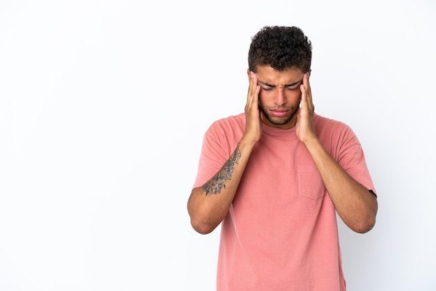 Young handsome Brazilian man isolated on white background with headache