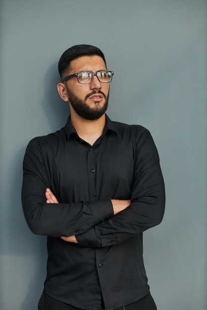 Young handsome business man dressed in casual denim shirt with smartwatch on wrist