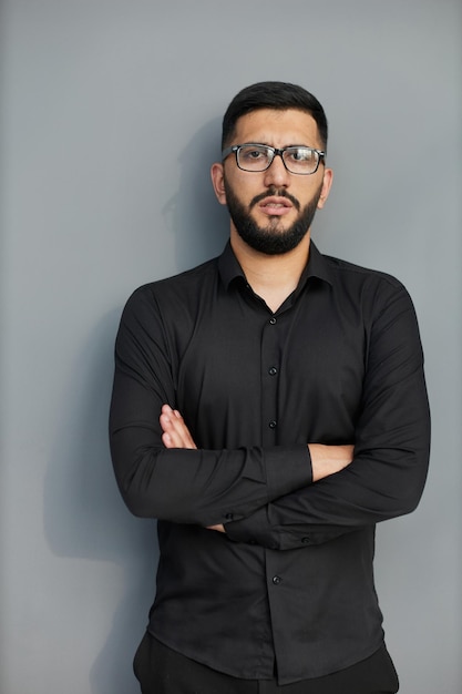 Young handsome business man dressed in casual denim shirt with smartwatch on wrist