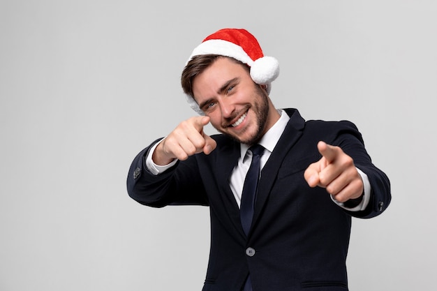 Young handsome caucasian guy in business suit and Santa hats 