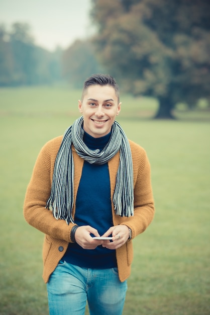 young handsome caucasian man in autumn park