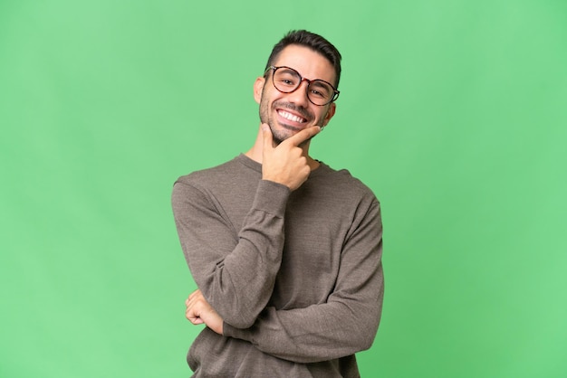 Young handsome caucasian man over isolated background happy and smiling