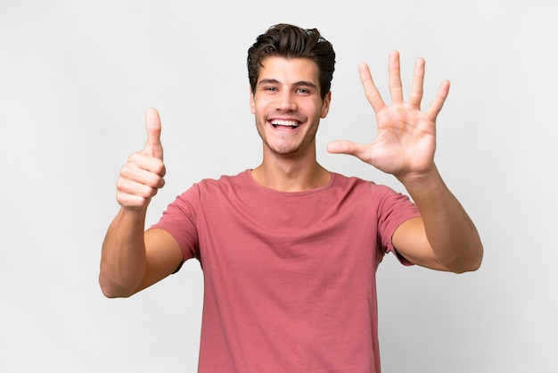 Young handsome caucasian man over isolated white background counting six with fingers