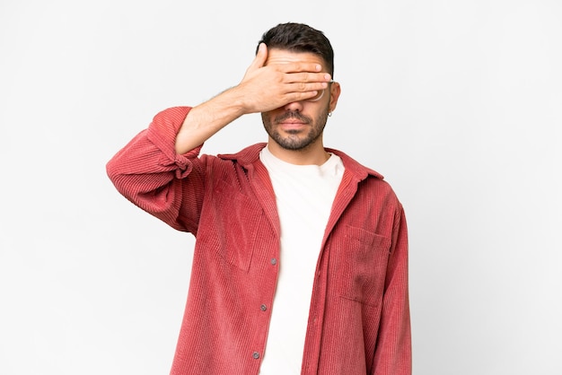 Young handsome caucasian man over isolated white background covering eyes by hands Do not want to see something