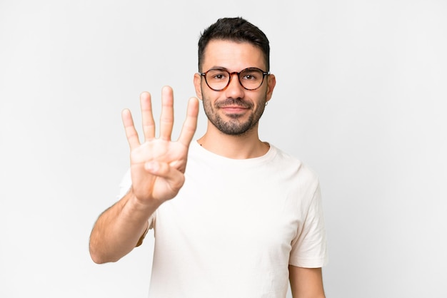 Young handsome caucasian man over isolated white background happy and counting four with fingers