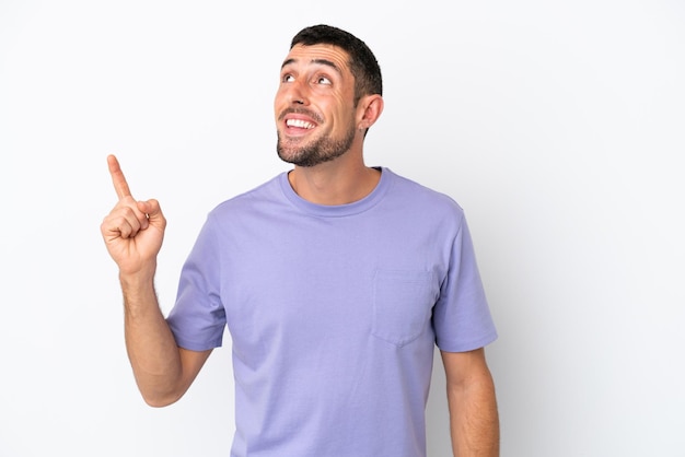 Young handsome caucasian man isolated on white background intending to realizes the solution while lifting a finger up