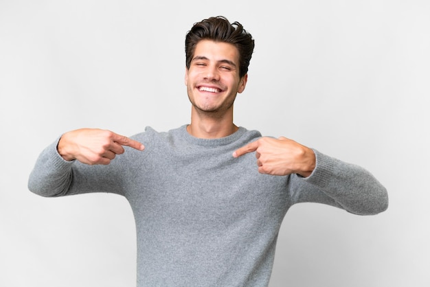 Young handsome caucasian man over isolated white background proud and selfsatisfied