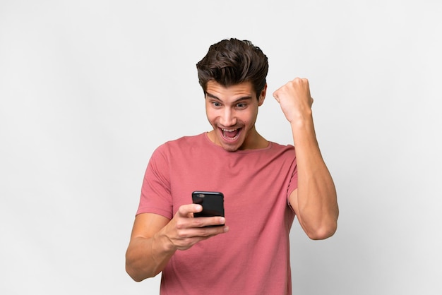 Young handsome caucasian man over isolated white background surprised and sending a message