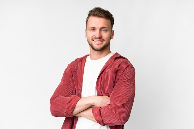 Photo young handsome caucasian man over isolated white background with arms crossed and looking forward