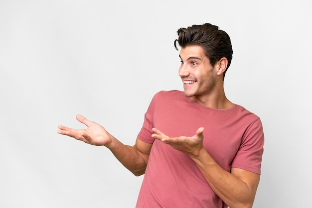 Young handsome caucasian man over isolated white background with surprise facial expression