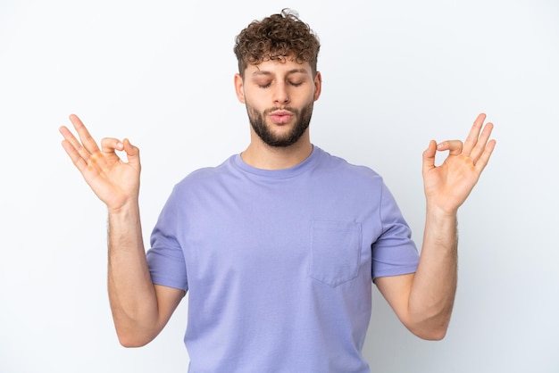 Young handsome caucasian man isolated on white background in zen pose