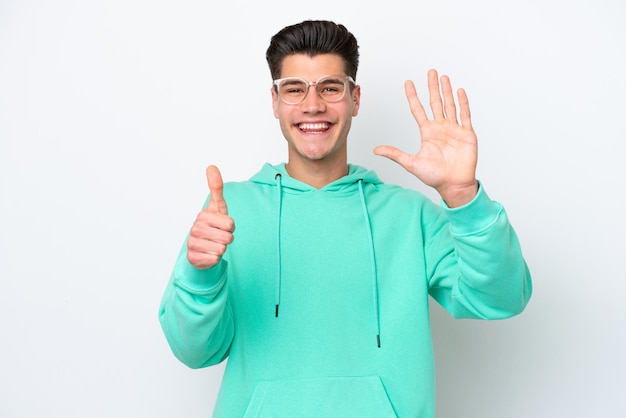 Young handsome caucasian man isolated on white bakcground counting six with fingers