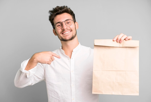 Young handsome employee man with a take away food paper bag