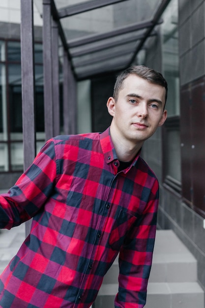 young handsome guy in a red checkered shirt