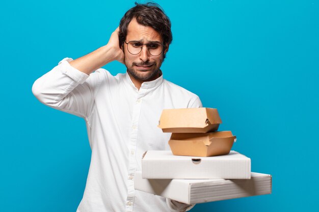 Young handsome indian man take away fast food concept