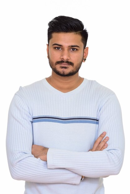 Young handsome Indian man with arms crossed