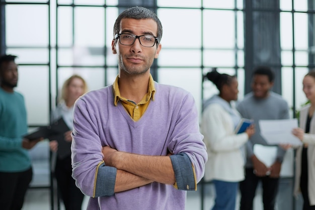 Young handsome man in elegant clothes and glasses looks away