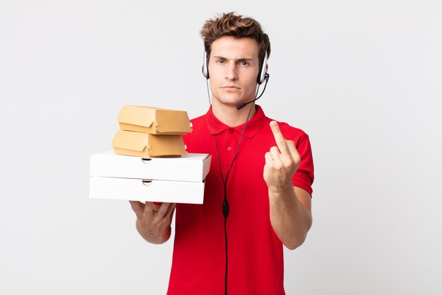 young handsome man feeling angry, annoyed, rebellious and aggressive. take away fast food concept