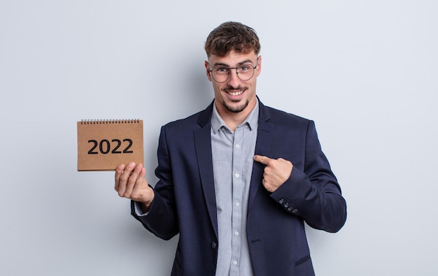 Young handsome man feeling happy and pointing to self with an excited. calendar concept