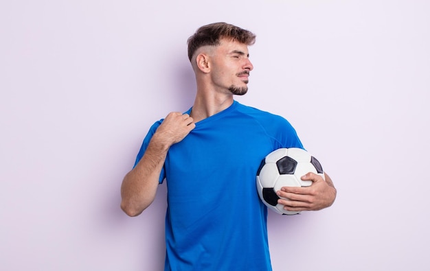 Young handsome man feeling stressed, anxious, tired and frustrated. soccer concept