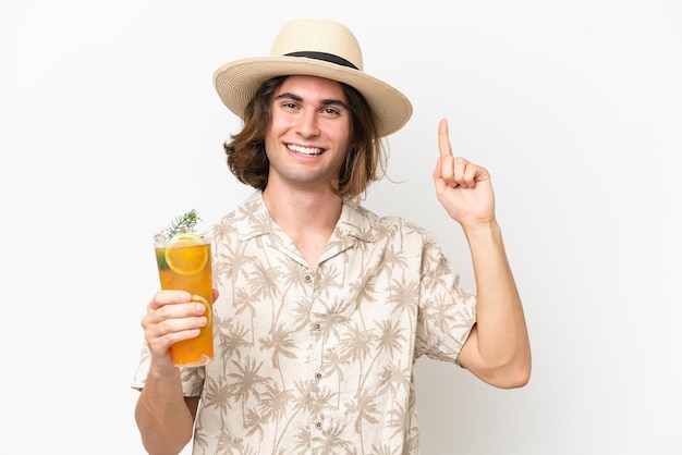 Young handsome man holding a cocktail isolated on white background pointing up a great idea