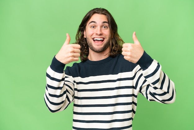 Young handsome man over isolated background giving a thumbs up gesture