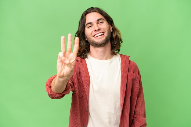 Young handsome man over isolated background happy and counting three with fingers