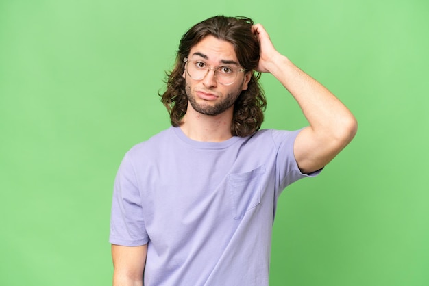 Young handsome man over isolated background having doubts