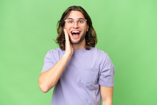 Young handsome man over isolated background with surprise and shocked facial expression