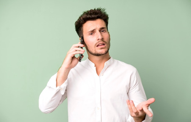 Young handsome man isolated using his telephone