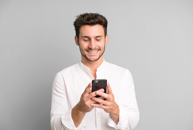 Young handsome man isolated using his telephone