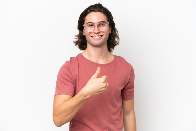 Young handsome man isolated on white background giving a thumbs up gesture