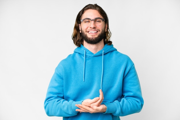 Young handsome man over isolated white background laughing