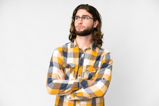 Young handsome man over isolated white background looking to the side