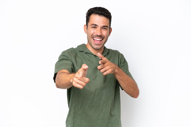 Young handsome man over isolated white background pointing to the front and smiling