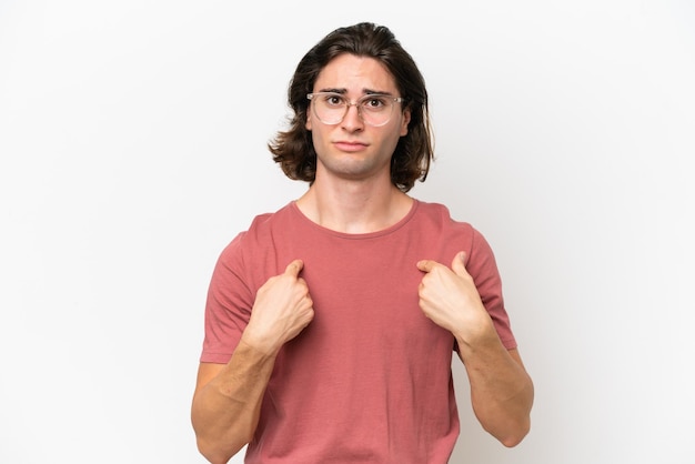 Young handsome man isolated on white background pointing to oneself