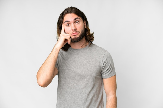 Young handsome man over isolated white background thinking an idea