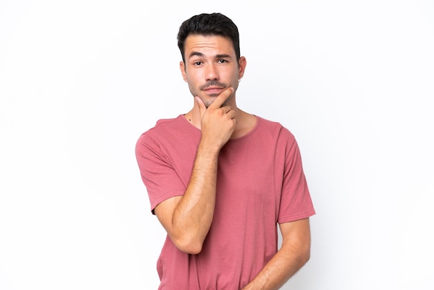 Young handsome man over isolated white background thinking